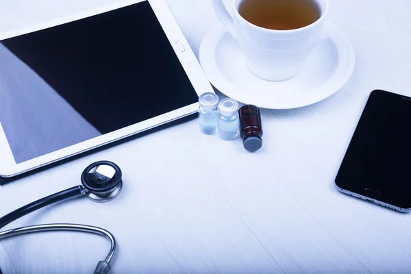 Medical devices on the table at the doctor with blue toned