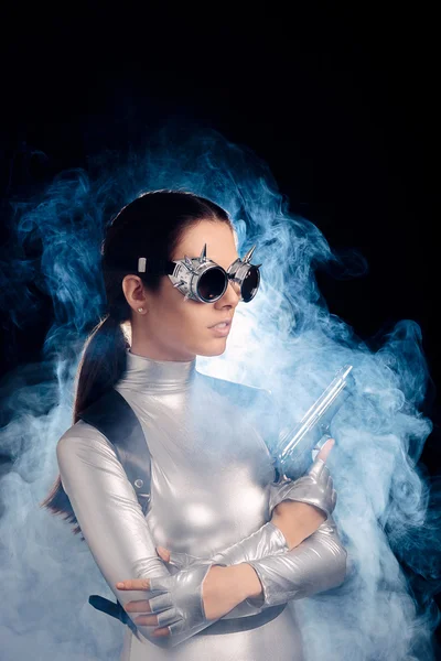 Woman in Silver Space Costume Holding Pistol Gun