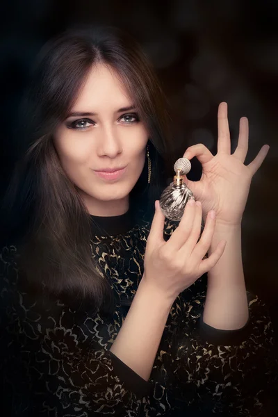 Retro glamour woman holding vintage perfume bottle