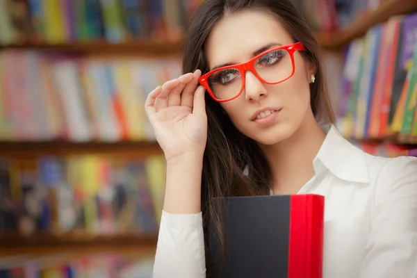 Young Woman Wearing  Glasses and Holding a Book