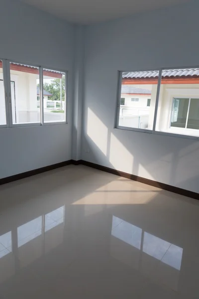 Room with sliding window and beige tile floor