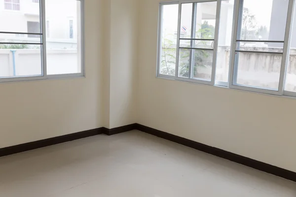 Room with sliding window and beige tile floor