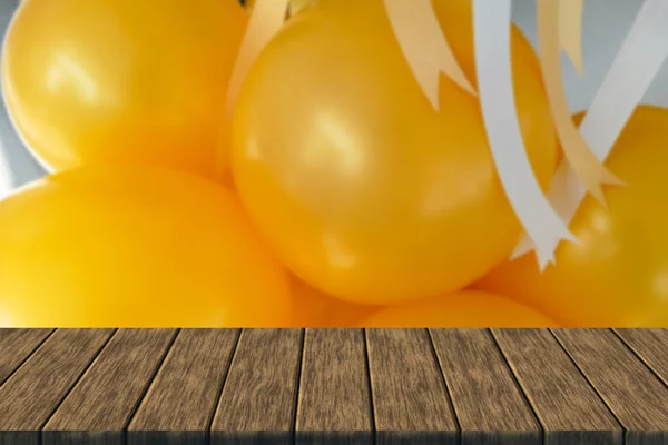 Yellow balloon and yellow and white ribbon