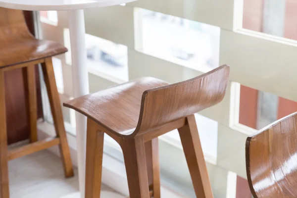 Wooden stool with round table at the balcony