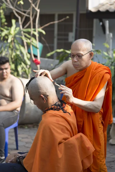 Monk shave man\'s hair before buddhist monk ordination ceremony