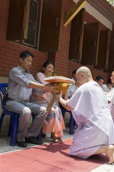 Man receive monk robe from their parent in buddhist monk ordinat