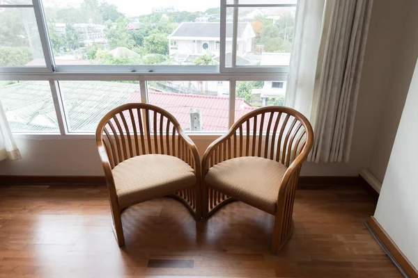 Wooden chair beside window