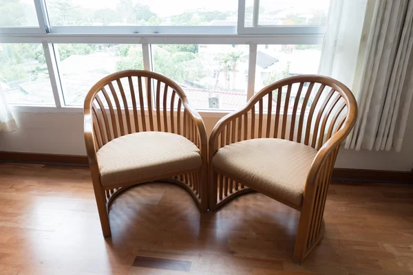 Wooden chair beside window