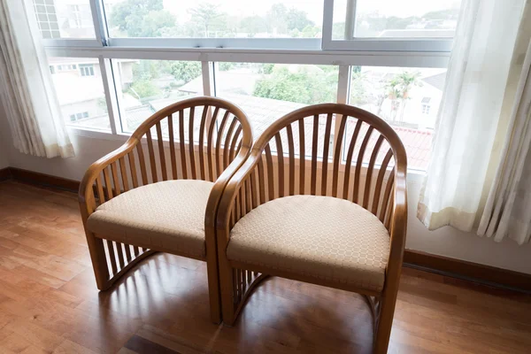 Wooden chair beside window