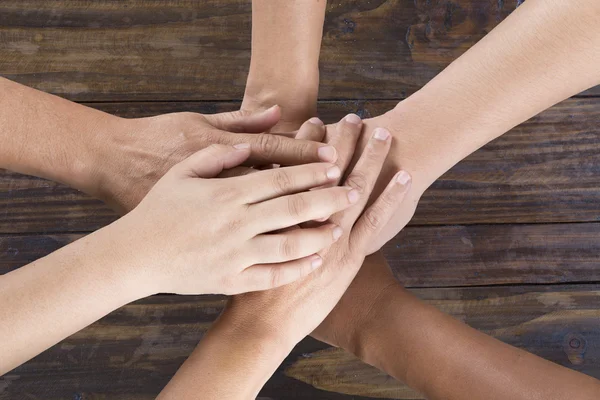People put hand together for use as unity teamwork concept