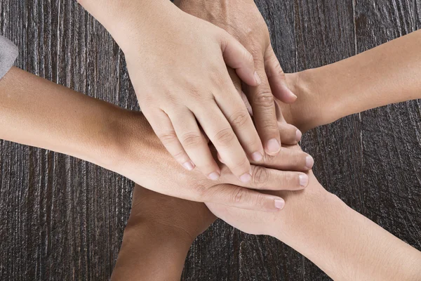 People put hand together for use as unity teamwork concept