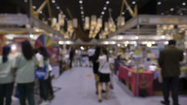 People shopping in exhibiton trade fair - blur
