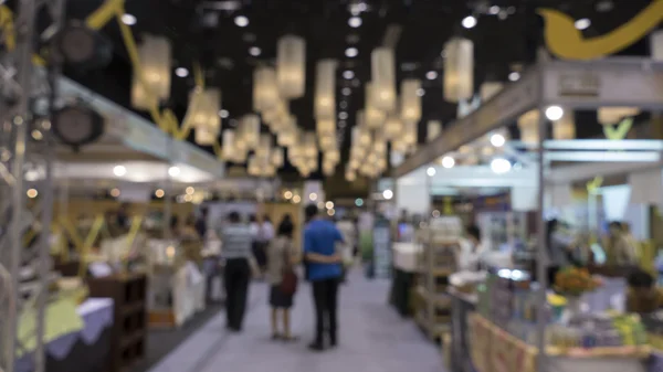 People shopping in exhibiton trade fair - blur