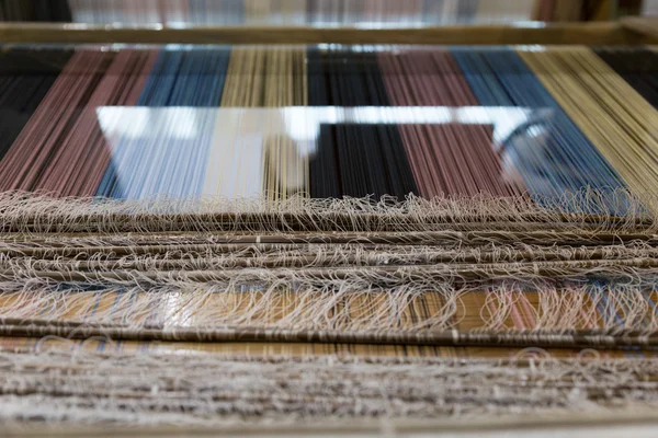 Traditional hand-weaving loom being used to make cloth