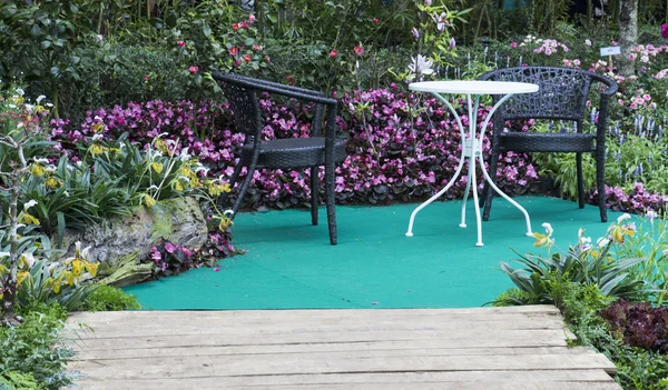 Table and chair in hedge of garden