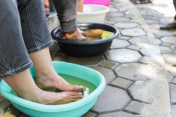 Foot soaking in herbal water