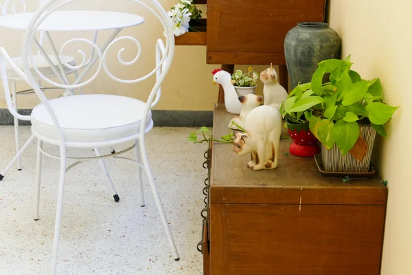 White chair and desk and plant decorating on wooden desk drawer