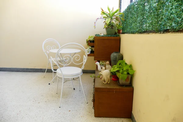 White chair and desk and plant decorating on wooden desk drawer