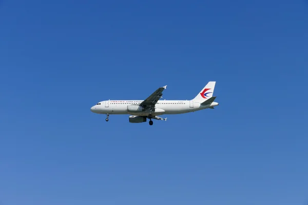 The airplane of China Eastern Airlines is flying in blue sky