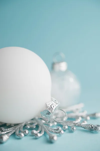 White xmas ornaments on light blue background. Merry christmas card. Winter holidays. Xmas theme. Happy New Year.