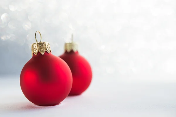 Red xmas ornaments on glitter holiday background. Winter holidays. Xmas theme. Happy New Year.