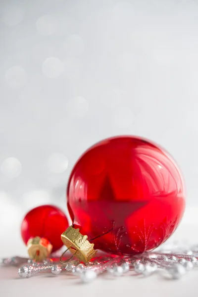 Red xmas ornaments on glitter holiday background. Merry christmas card. Winter holidays. Xmas theme. Happy New Year.