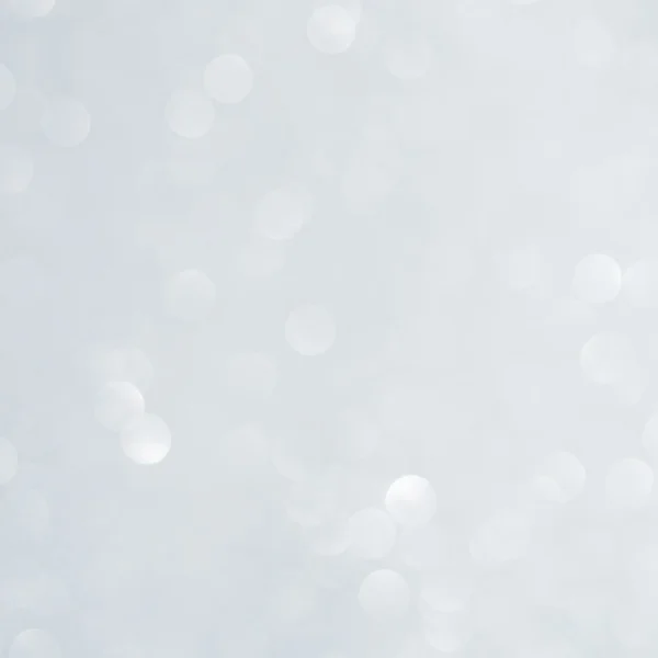 Unfocused abstract white glitter bokeh holiday background. Winter xmas holidays. Christmas.