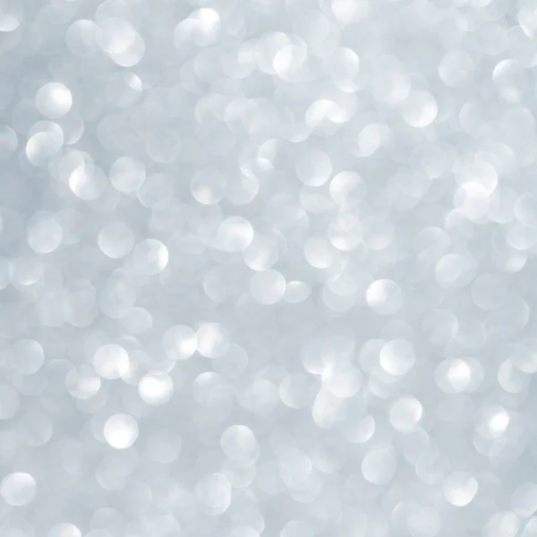 Unfocused abstract light blue glitter holiday background. Christmas theme.