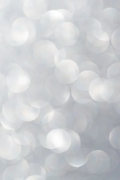 Unfocused abstract silver glitter holiday background. Winter xmas holidays. Christmas.
