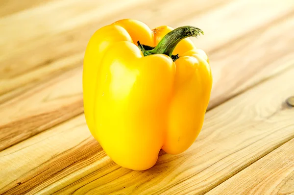 Yellow pepper on chopping block