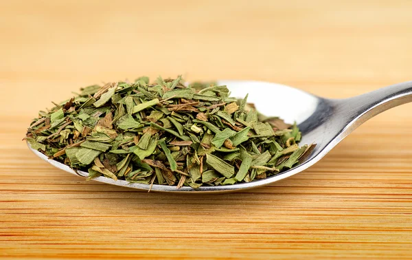 Spoonful of aromatic tarragon herb