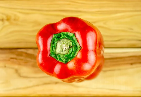 Aerial macro of juicy red pepper on chopping board