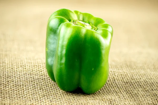 Delicious green pepper on burlap sack