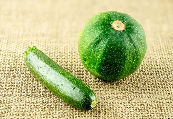 Ripe dark green baby zucchini and round gem squash