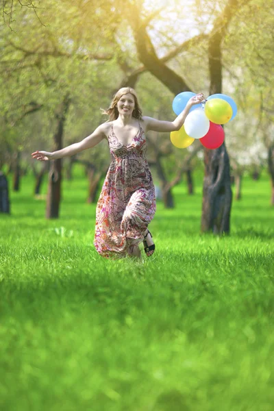 Modern Lifestyle Concept. Young Caucasian Blond Female with Bunch of Colorful Air Balloons