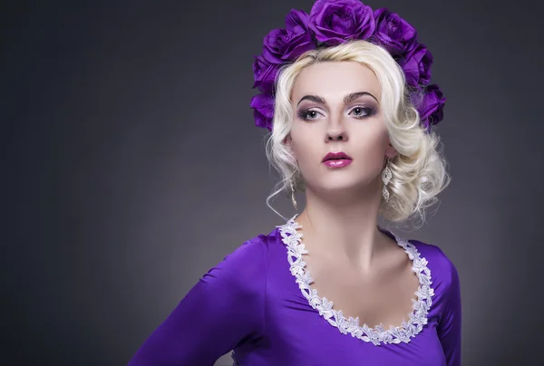 Beauty Concept and Ideas. Caucasian Female Posing in Purple Dress with Flowery Violet Crown