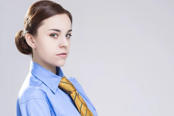 Sensual Caucasian Brunette Business Woman in in Official Blue Shirt and Orange Tie.