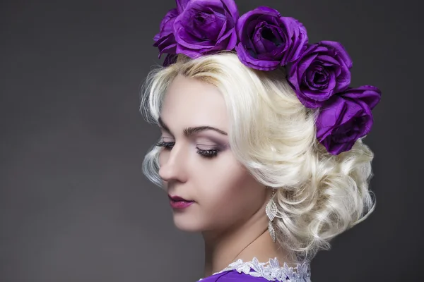 Closeup Portrait of Blond Woman Wearing Unique Flowery Purple Crown.