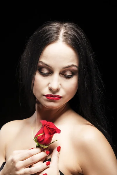 Beauty Concept and Ideas. Portrait of Caucasian Brunette Female Posing With Rose