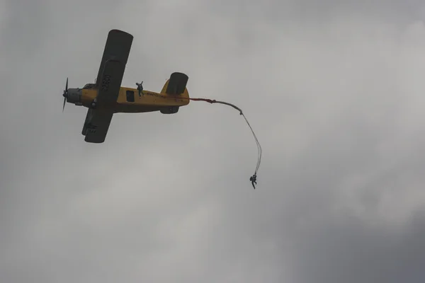 Airplane AN-2 on Air with Parachuters Team Jumping Out During Aviation Sport Event Dedicated to 80th Anniversary of DOSAAF Foundation