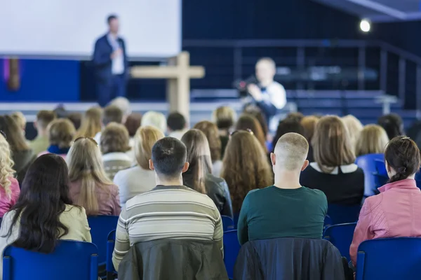 Business Conferences Concept and Ideas. Male Professional Lecturer Speaking In front of the Group of People.