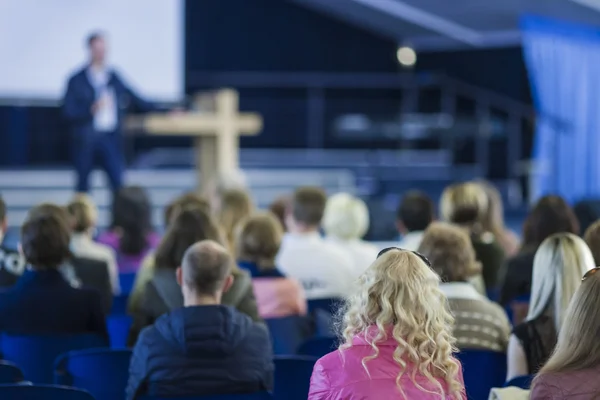 Business Conferences Concept and Ideas. Male Professional Lecturer Speaking In front of the Group of People