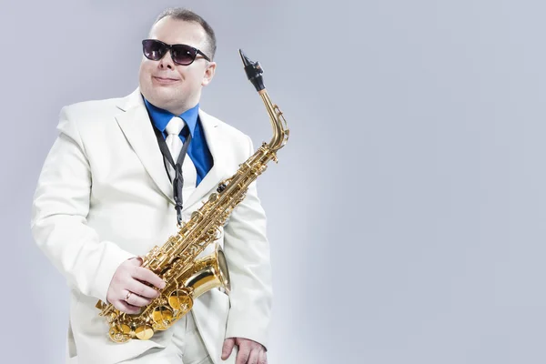 Portrait of Passionate Expressive Male Alto Saxophone Player in White Suit