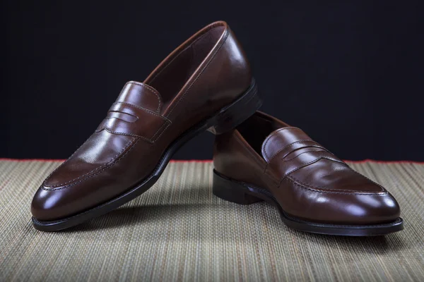 Footwear Concepts and Ideas. Pair of Stylish Expensive Modern Calf Leather Brown Penny Loafers