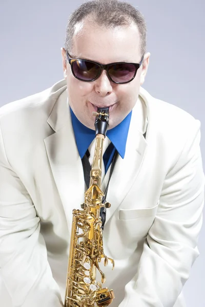 Humorous Male Saxophone Player Performing On Alto Saxo In White Suit and Sunglasses