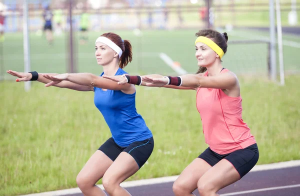 Sport Concepts and Ideas. Two Professional Female Athletes Having Training At Sport Venue