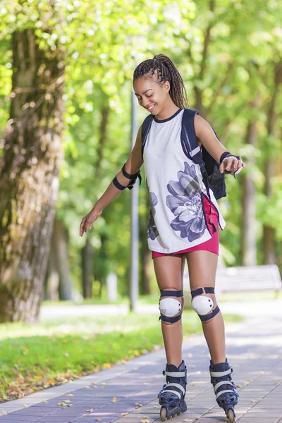 Sport Concepts. Young African American Teenage Girl Learning Roller Skating in Park Area.
