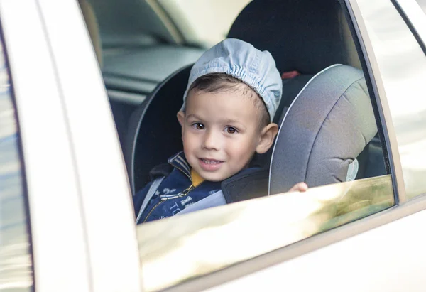 Safety Concept: Portrait of Young Caucasian happy Little Boy Sit