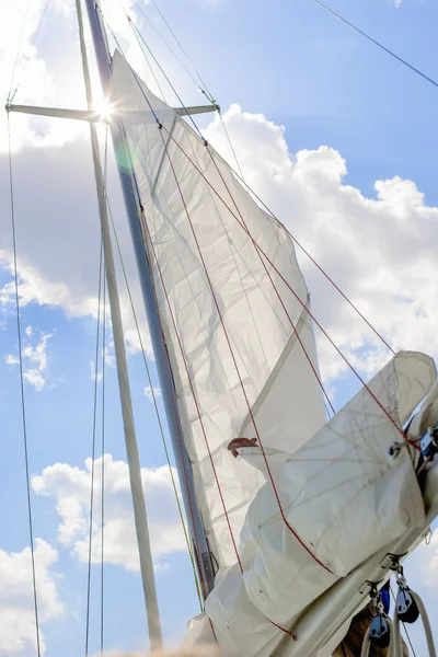 Closeup View of Mid-Size Yacht Mast and Canvas Sail Shot Against