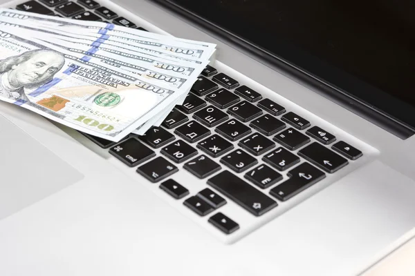 E-Trade and E-Commerce Ideas and Concepts. Stack of Banknotes on Laptop